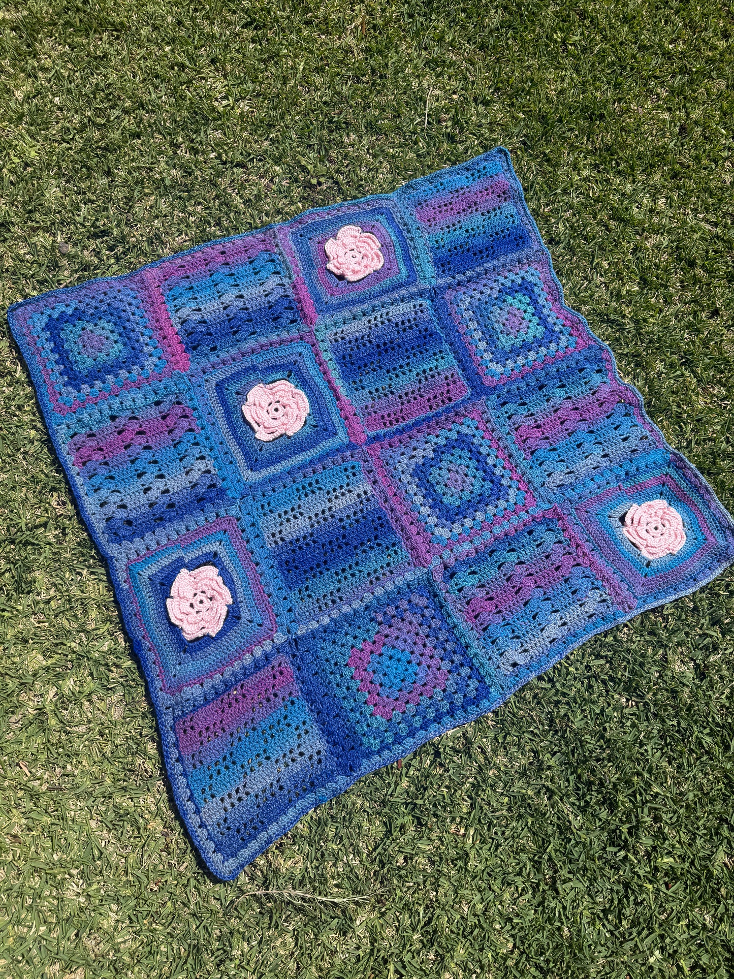Granny Square Crochet Blanket with Pink Flower Accents – Handmade by Lyndsay