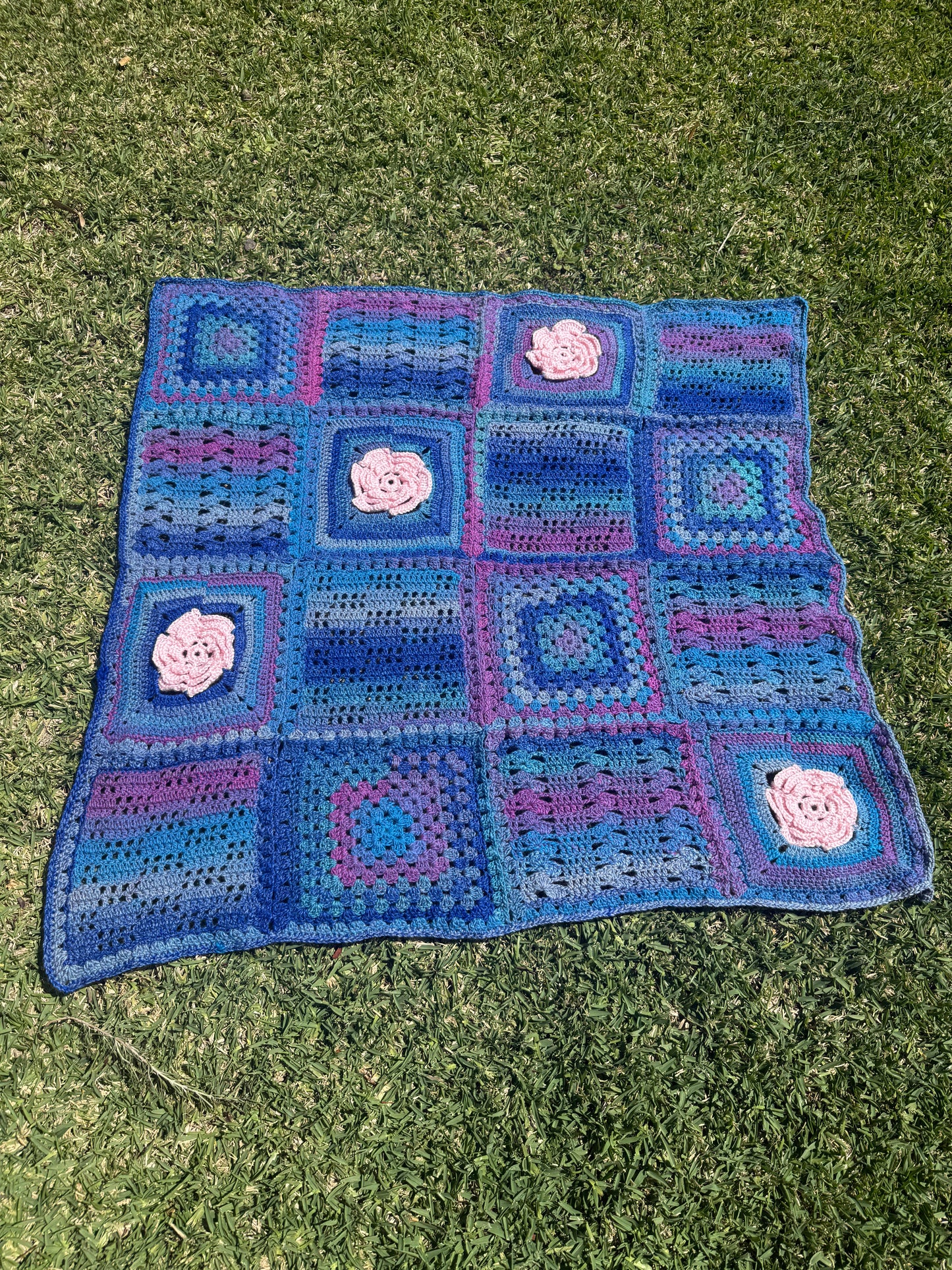 Granny Square Crochet Blanket with Pink Flower Accents – Handmade by Lyndsay